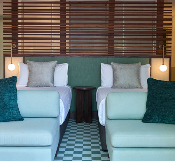 Image front onto the the main bedroom showing split king beds