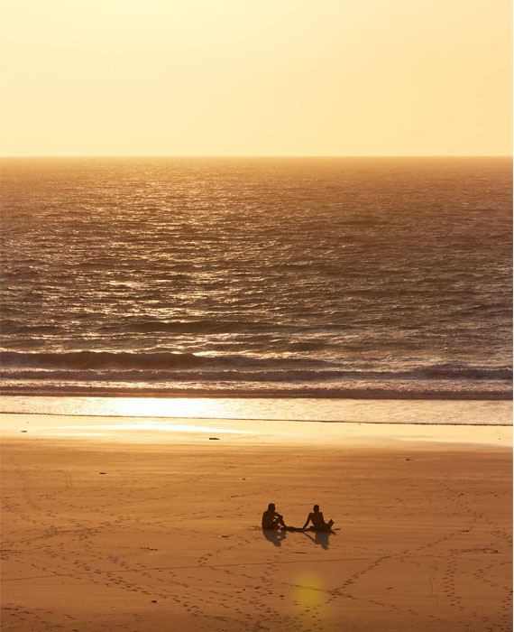 Image of a couple enjoying a sunset at Cable Beach